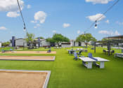 Thumbnail 29 of 41 - a park with picnic tables and benches on the grass