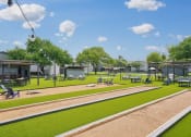 Thumbnail 30 of 41 - a rendering of a park with grass and tables and chairs