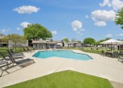 Thumbnail 23 of 41 - the preserve at ballantyne commons pool and patio with chairs and umbrellas