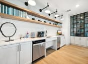 Thumbnail 22 of 38 - a kitchen with white cabinets and a sink and a dishwasher