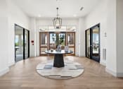 Thumbnail 19 of 38 - a foyer with a circular rug and a table in the middle
