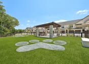 Thumbnail 31 of 38 - a yard with green grass and a building in the background
