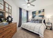 Thumbnail 9 of 38 - a bedroom with a bed and a ceiling fan
