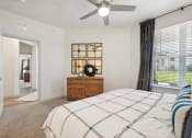 Thumbnail 10 of 38 - a bedroom with a large bed and a ceiling fan