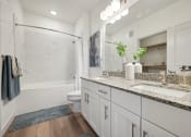 Thumbnail 16 of 38 - a bathroom with a sink and a shower and a toilet