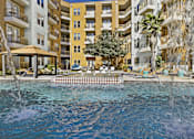 Thumbnail 30 of 35 - a large pool with a building in the background