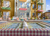 Thumbnail 32 of 35 - a pool with a fountain in front of a building