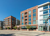 Thumbnail 48 of 55 - A large building with a lot of windows is in the foreground.