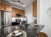 Thumbnail 5 of 35 - a kitchen with a large island and stainless steel appliances