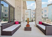 Thumbnail 15 of 21 - a patio with couches and a coffee table