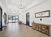Thumbnail 7 of 21 - the preserve at gateway living room with wood flooring and a wooden table