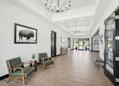 Thumbnail 11 of 21 - a long hallway with chairs and a large picture of a bull