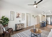 Thumbnail 3 of 21 - a living room with a ceiling fan and a dining room table
