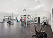 Thumbnail 13 of 21 - a gym with weights and cardio equipment in a building with white walls