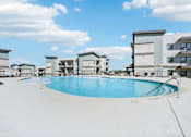 Thumbnail 19 of 21 - a large swimming pool with apartments in the background