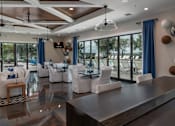 Thumbnail 31 of 50 - a large living room with white chairs and blue curtains