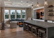 Thumbnail 33 of 50 - a kitchen with a long counter top and a living room in the background