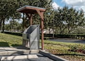 Thumbnail 46 of 50 - a parking meter in a park with trees in the background