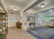 Thumbnail 10 of 23 - a living room with a blue rug and a window