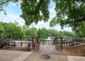 Thumbnail 18 of 23 - a deck overlooking a body of water with trees and a fountain