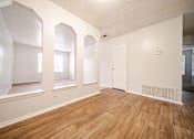 Thumbnail 10 of 47 - the living room and dining room of an apartment with wood floors and white walls