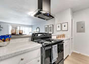 Thumbnail 7 of 30 - a kitchen with a stove and a refrigerator