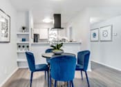 Thumbnail 6 of 30 - a dining room with blue chairs and a table
