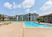 Thumbnail 7 of 24 - the preserve at ballantyne commons swimming pool with apartment buildings in the background