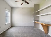 Thumbnail 21 of 24 - an empty room with a desk and a ceiling fan