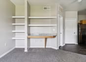 Thumbnail 22 of 24 - an empty room with white shelves and a counter and a door
