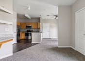 Thumbnail 20 of 24 - an empty kitchen and living room with a ceiling fan