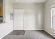Thumbnail 19 of 24 - an empty room with a white door and a window