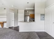 Thumbnail 17 of 24 - an empty living room and kitchen with white doors