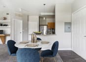 Thumbnail 2 of 24 - a dining room with a table and chairs and a kitchen
