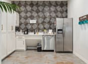 Thumbnail 15 of 24 - a white kitchen with a stainless steel refrigerator and sink