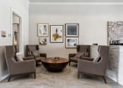 Thumbnail 14 of 24 - a living room with brown chairs and a table