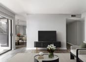 Thumbnail 5 of 30 - a living room with a flatscreen tv and a table
