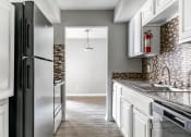 Thumbnail 26 of 30 - the kitchen of a new home with white cabinets and stainless steel appliances