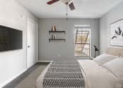 Thumbnail 4 of 30 - a bedroom with a large bed and a ceiling fan