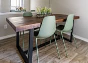 Thumbnail 25 of 30 - a dining room with a wooden table and green chairs