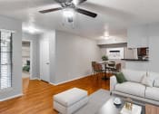 Thumbnail 1 of 15 - an open living room and dining room with a couch and a table