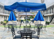 Thumbnail 11 of 13 - a patio with tables and umbrellas in a hotel courtyard