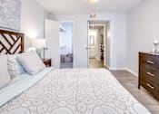 Thumbnail 10 of 12 - A bedroom with a large bed and a wooden headboard.