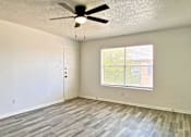 Thumbnail 19 of 31 - A room with a ceiling fan and a window with blinds.