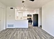 Thumbnail 16 of 31 - A spacious kitchen with a bar counter and a ceiling fan.