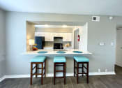 Thumbnail 13 of 31 - a kitchen with a breakfast bar and a kitchen in the background  at The Alara, Houston