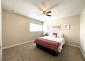 Thumbnail 6 of 13 - a bedroom with a bed and a ceiling fan