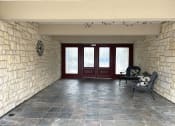 Thumbnail 13 of 13 - a view of the front porch of a house with red doors and a stone wall
