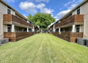 Thumbnail 8 of 16 - a yard in the middle of a row of apartment buildings