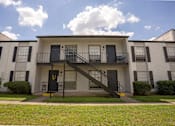 Thumbnail 2 of 27 - A white two-story apartment building
